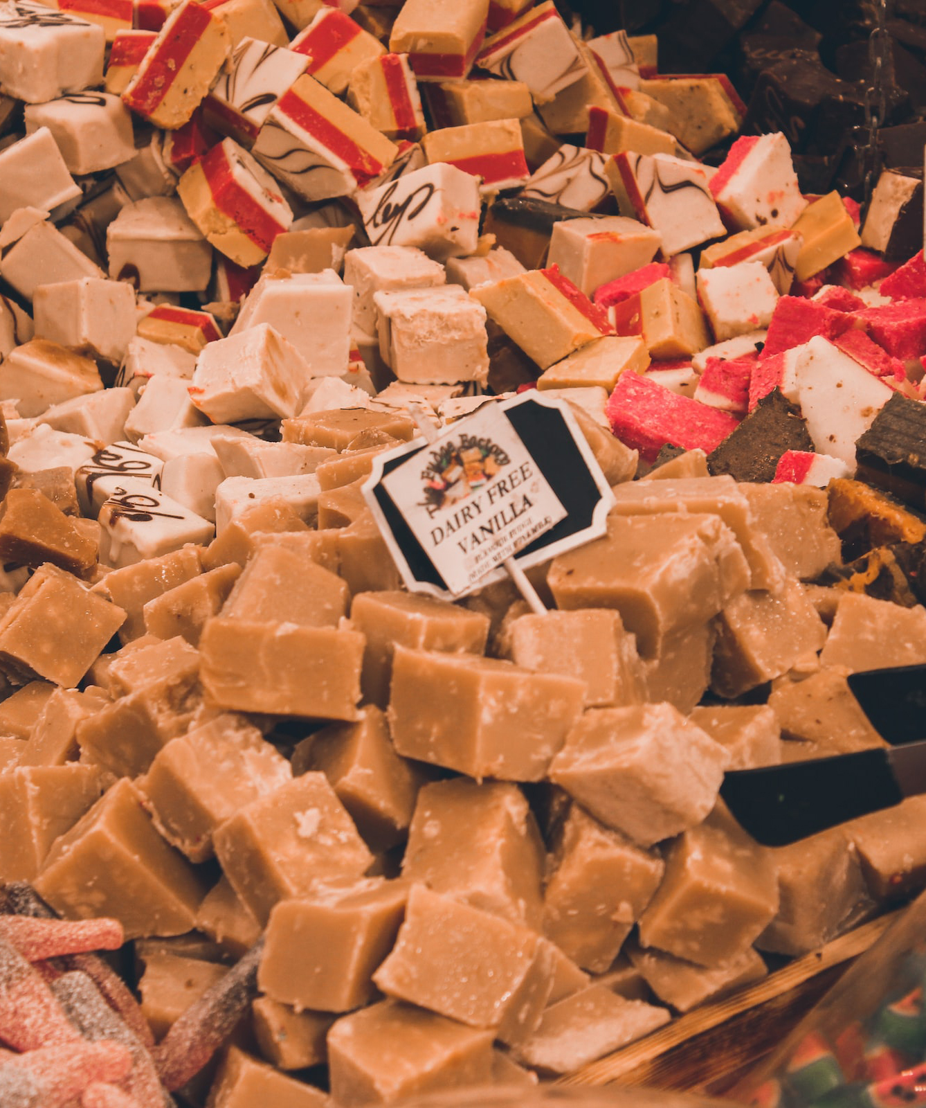 a market stall piled high with different flavoured fudges